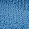 A close-up, angled view of a blue foam mattress topper with a textured surface. Produktbild-Vorschau