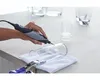 A person is using a Dremel tool to engrave a glass. Anteprima dell’immagine prodotto