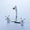 A chrome-finished faucet with two cross-shaped handles, mounted on a light gray background. Produktbild-Vorschau