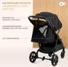 A black stroller is shown against a light wood-paneled background, with text overlays highlighting its features. Podgląd zdjęcia produktu