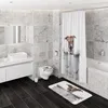 A modern bathroom with marble-tiled walls and dark wood flooring, featuring a toilet with a novelty seat cover and a matching bath mat, and a shower curtain with a dog print. Náhled obrázku produktu