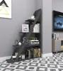 A dark gray, ladder-style bookshelf filled with books and decorative items, placed in a corner of a room with a gray wall and a patterned floor. Náhled obrázku produktu