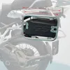 A close-up view of a motorcycle's rear section, focusing on a black storage box mounted on a silver rack. Anteprima dell’immagine prodotto
