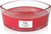 A red candle in a clear glass container with a wooden wick. Produktbild-Vorschau