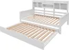 A white wooden daybed with a pull-out trundle bed is shown against a white background. The daybed has a slatted headboard with built-in shelving. Náhled obrázku produktu