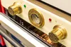 Close-up of the control panel of a cream-colored oven with gold accents. Produktbild-Vorschau