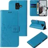 A collage of images showing a blue flip phone case with a floral and butterfly design from multiple angles. Produktbild-Vorschau