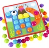 A colorful button mosaic toy with a dinosaur and volcano theme, with many colorful buttons scattered around the board. Produktbild-Vorschau
