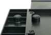 Close-up view of the bottom of a black plastic organizer, showing two rubber feet and screws. Náhľad obrázku produktu