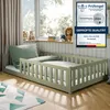 A child's bed with bedding and stuffed animals in a room with striped wallpaper and curtains. Voir les images du produit