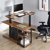 A standing desk with a computer, monitor, and accessories in a home office setting. Produktbild-Vorschau