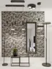 A modern living room setting with a patterned wall, a large mirror, and various lighting fixtures. Náhľad obrázku produktu
