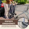 A person is using a shopping trolley next to a car and a supermarket trolley. Anteprima dell’immagine prodotto