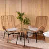 A small outdoor seating set with two chairs and a table, placed on a rug in front of a wooden wall. Náhled obrázku produktu
