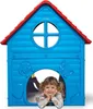 A young girl is lying inside a blue plastic playhouse with a red roof. Náhľad obrázku produktu
