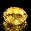 A coiled string of warm white LED lights on a reflective black surface. Produktbild-Vorschau