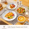 A table setting with various dishes including salmon, pasta, soup, and waffles, suggesting a meal. Náhled obrázku produktu