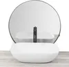 A white oval countertop sink with a black faucet is shown in front of a round mirror. Náhled obrázku produktu