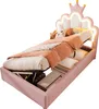 A pink princess-themed bed with a crown-shaped headboard and LED lighting, shown with its storage compartment open. Produktbild-Vorschau
