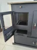 A close-up view of a beige and dark gray wood-burning stove with its door open. Produktbild-Vorschau