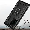 A black phone case with a ring holder is shown in a dynamic, falling pose, with debris scattering around it. Produktbild-Vorschau