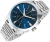 A close-up, angled view of a men's wristwatch with a blue dial and silver band, set against a white background. Produktbild-Vorschau