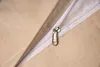 A close-up view of a zipper on a beige fabric item. Produktbild-Vorschau