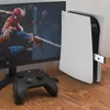 A gaming setup with a monitor displaying Spider-Man, a game console, and a controller. Produktbild-Vorschau