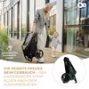A woman and a child are walking outdoors with a folded stroller. Produktbild-Vorschau