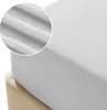 A close-up view of a gray fitted sheet on a bed. Podgląd zdjęcia produktu