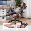 A woman relaxing in a pink gaming chair with her feet up on a footrest. Produktbild-Vorschau