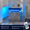 A modern nightstand with RGB LED lighting is shown in a room setting, with a sofa visible in the background. Produktbild-Vorschau