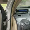 A close-up view of a car's interior dashboard with a digital device attached. Produktbild-Vorschau