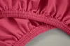 A close-up view of the elasticized edge of a pink fabric. Produktbild-Vorschau