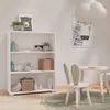 A child's room with a white bookshelf, a small table and chair, and a rug. Produktbild-Vorschau