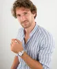 A man wearing a blue and white striped shirt and a silver watch. Náhľad obrázku produktu