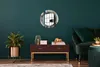 A modern living room with a dark green wall, featuring a round mirror with an abstract design, a wooden console table with decorative items, and a green sofa. Produktbild-Vorschau