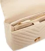 Close-up view of the interior of a beige handbag, showing the zipper and compartments. Voir les images du produit
