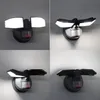 A collage of four images showing a black LED floodlight with a motion sensor, mounted on a wall. The floodlight has two adjustable heads that emit bright white light. Produktbild-Vorschau