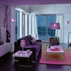 A modern living room with purple accents, featuring a sofa, armchair, coffee table, and floor. Produktbild-Vorschau