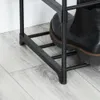 Close-up view of the bottom section of a black metal shoe rack with a black boot on it, placed on a light gray wooden floor. Náhled obrázku produktu