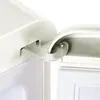 A close-up view of the hinge mechanism of a refrigerator door. Produktbild-Vorschau