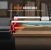A close-up view of a woodworking tool, specifically a height-adjustable sled, clamped onto a wooden surface with a resin inlay. Produktbild-Vorschau