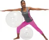 A woman is performing a yoga pose with two large exercise balls. Produktbild-Vorschau