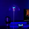 A desk setup with a lamp, headphones, and a tablet, all illuminated by blue light. Produktbild-Vorschau