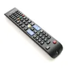A black remote control is shown against a white background. Voir les images du produit