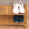A two-tier wooden shoe rack with shoes on both tiers. Podgląd zdjęcia produktu