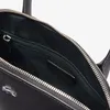 Close-up view of the interior of a black handbag, showing the zipper and a small leather tag with the brand name. Anteprima dell’immagine prodotto
