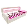 A beige upholstered daybed with a tufted headboard and footboard, featuring pink LED lighting underneath the mattress support and along the headboard. The mattress support is made of wooden slats. Produktbild-Vorschau