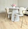 A dining table with chairs in a modern, bright room. Voir les images du produit
